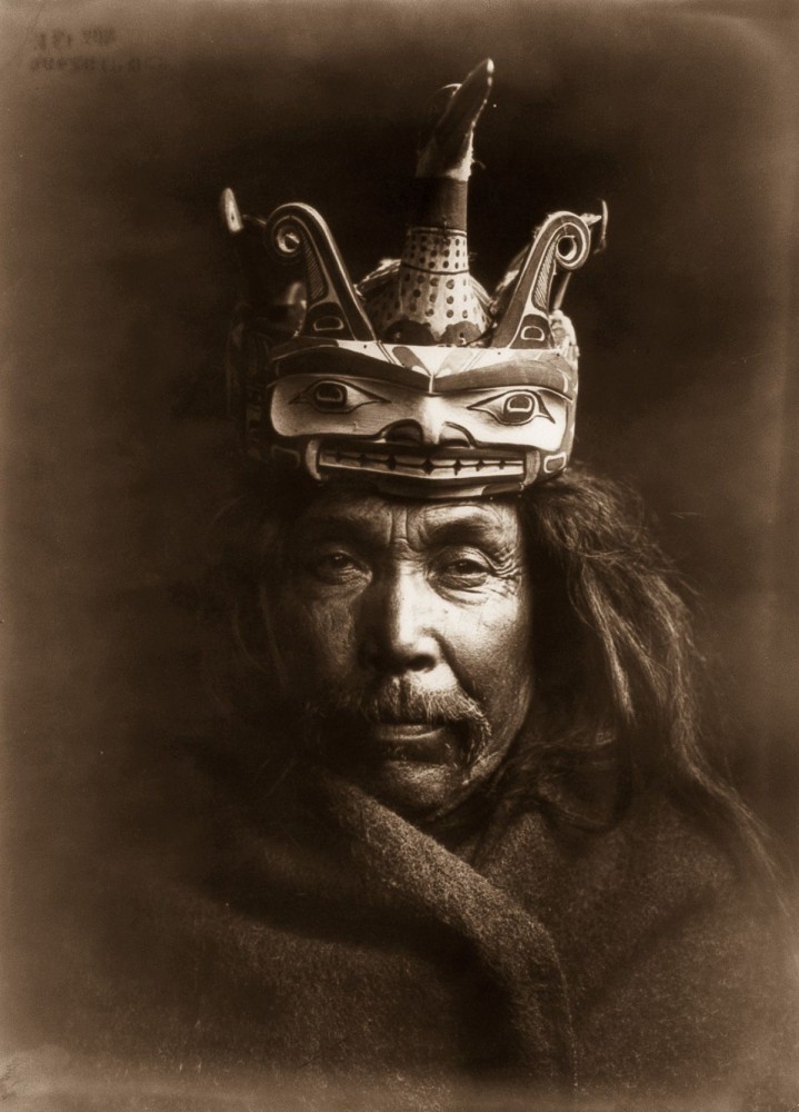 1914, A Kwakiutl man wearing a mask depicting a man transforming into a loon.