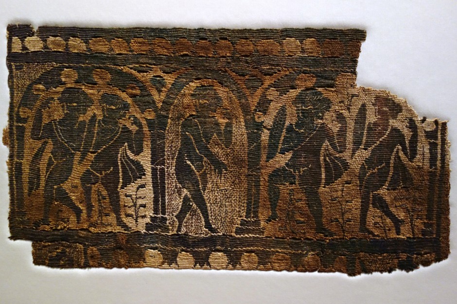 Panel, possibly from a tunic, representing Dionysian figures dancing, tapestry weave of dyed wool and undyed linen, plain (tabby) ground weave (Egypt, 6th century CE)